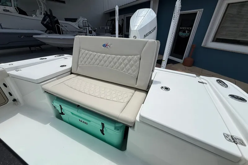 Slide: The Image of 2027 Crevalle 24 HCO boat interior with cushioned seating and storage compartments. - 5