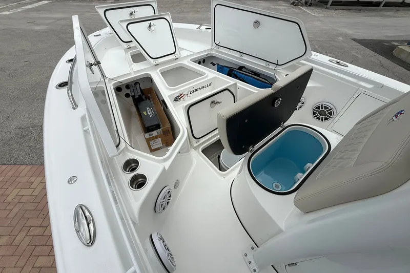 Slide: The Image of 2027 Crevalle 24 HCO boat interior with open storage compartments and seating. - 23