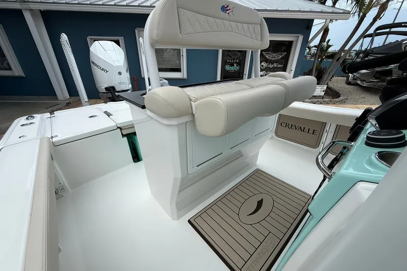 Slide: The Image of 2027 Crevalle 24 HCO boat interior with Mercury engine, featuring cushioned seating and sleek design. - 16