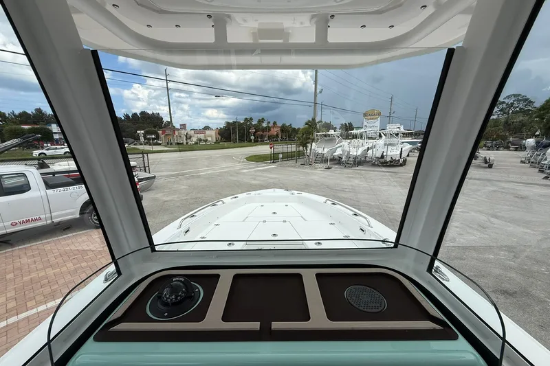 Slide: The Image of Interior view from a 2027 Crevalle 24 HCO boat, showcasing dashboard and windshield. - 15