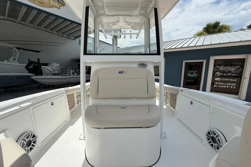 Slide: The Image of 2027 Crevalle 24 HCO boat interior with beige seating and modern design. - 27