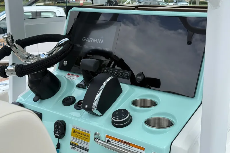 Slide: The Image of Helm of 2027 Crevalle 24 HCO boat with Garmin display and controls. - 13