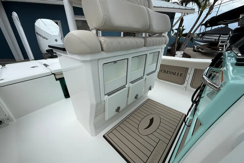 Slide: The Image of 2027 Crevalle 24 HCO boat interior with storage compartments and seating. - 17