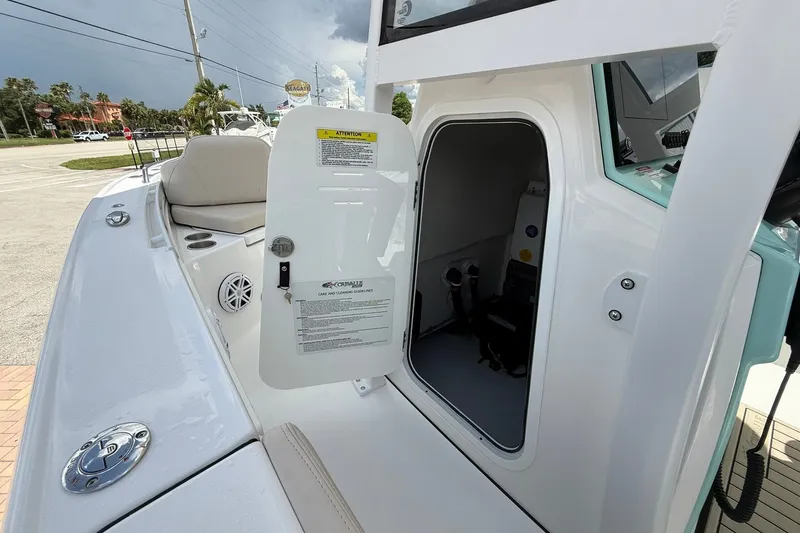 Slide: The Image of 2027 Crevalle 24 HCO boat with open storage compartment and seating area. - 28