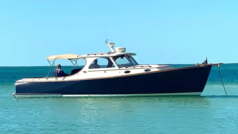 The Image of 1998 Hinckley 36 Classic yacht anchored in clear blue water. - 1