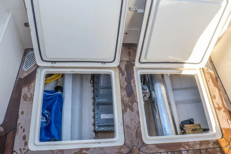 Slide: The Image of Open storage compartments on a 1998 Hinckley 36 Classic boat deck. - 28