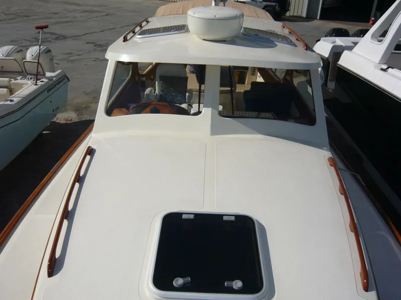 Slide: The Image of 1998 Hinckley 36 Classic yacht with sleek deck and cabin, docked at marina. - 18