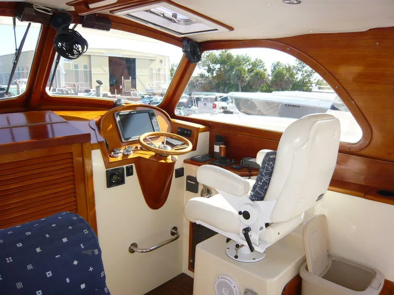 Slide: The Image of Interior of 1998 Hinckley 36 Classic boat with wooden dashboard and captain's chair. - 15