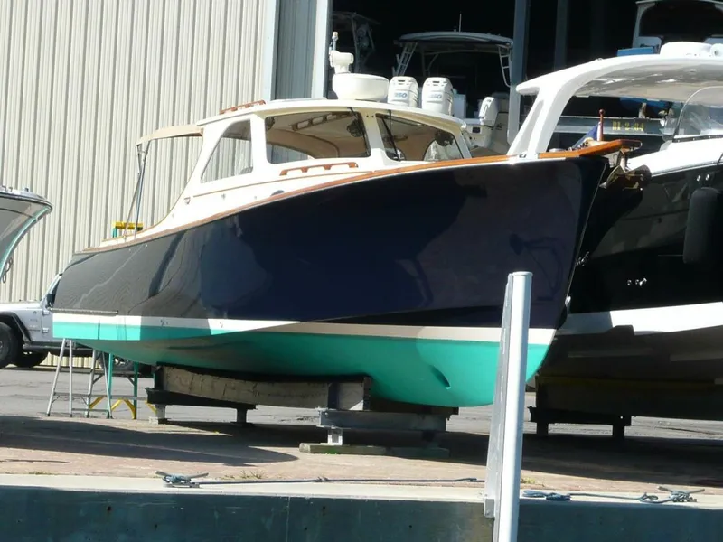 Slide: The Image of 1998 Hinckley 36 Classic boat in dry dock, showcasing elegant design and craftsmanship. - 30