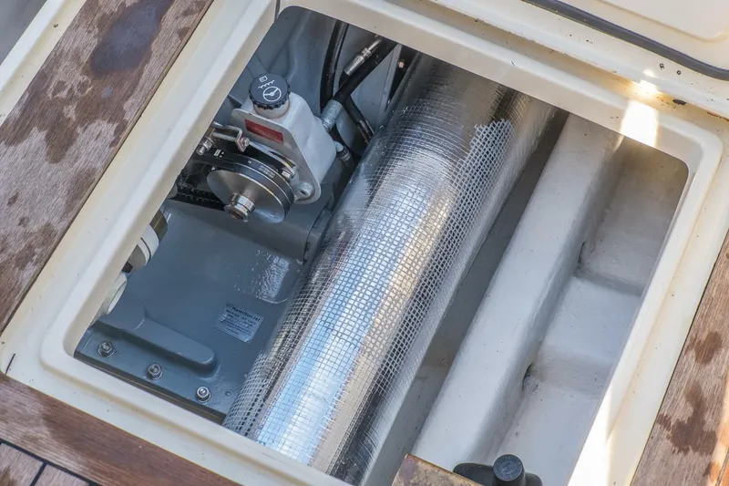 Slide: The Image of Engine compartment of a 1998 Hinckley 36 Classic boat, showcasing mechanical components. - 29