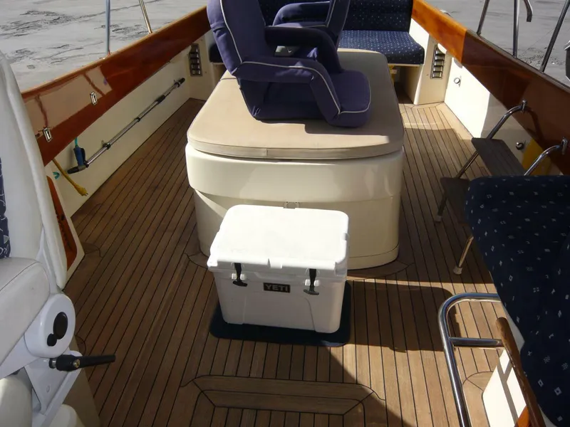 Slide: The Image of Hinckley 36 Classic 1998 boat interior with wooden deck and seating area. - 17