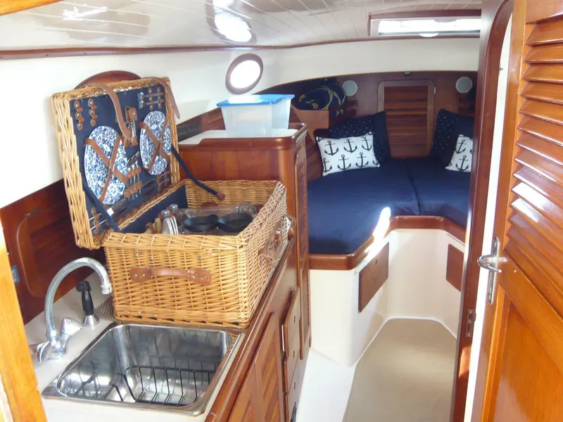 Slide: The Image of Cozy interior of 1998 Hinckley 36 Classic yacht with wicker basket and nautical decor. - 20
