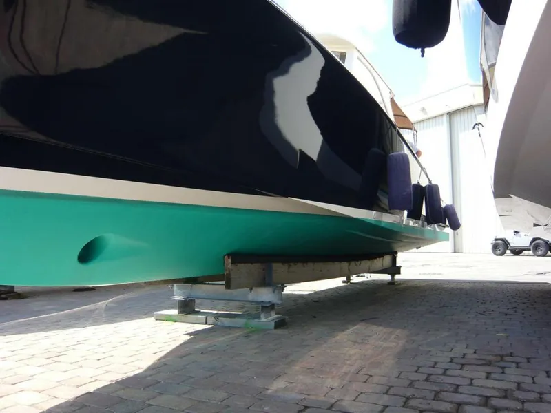 Slide: The Image of Hinckley 36 Classic 1998 boat on dry dock, showcasing hull and fenders. - 32