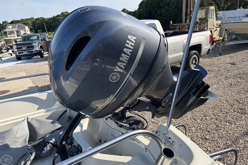 Slide: The Image of 1985 Boston Whaler 17 Montauk with Yamaha outboard motor, parked on gravel lot. - 14