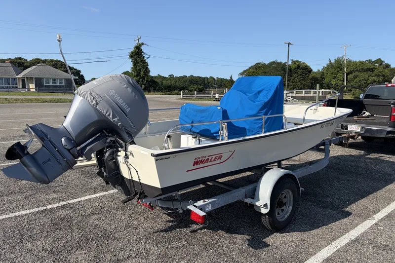 Slide: The Image of 1985 Boston Whaler 17 Montauk boat on trailer with Yamaha outboard motor. - 18