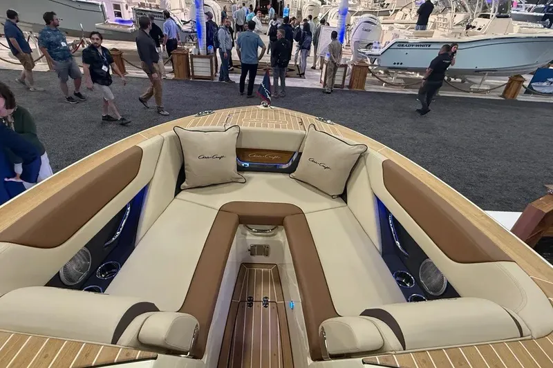 Slide: The Image of 2026 Chris-Craft Launch 27 boat interior at a boat show, featuring luxurious seating. - 8
