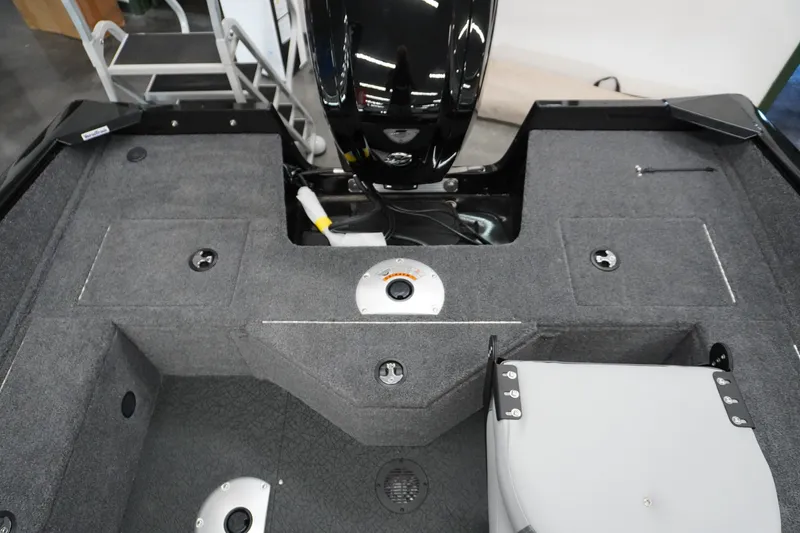 Slide: The Image of 2027 Tracker Pro Guide V-16 WT boat interior with carpeted deck and storage compartments. - 6