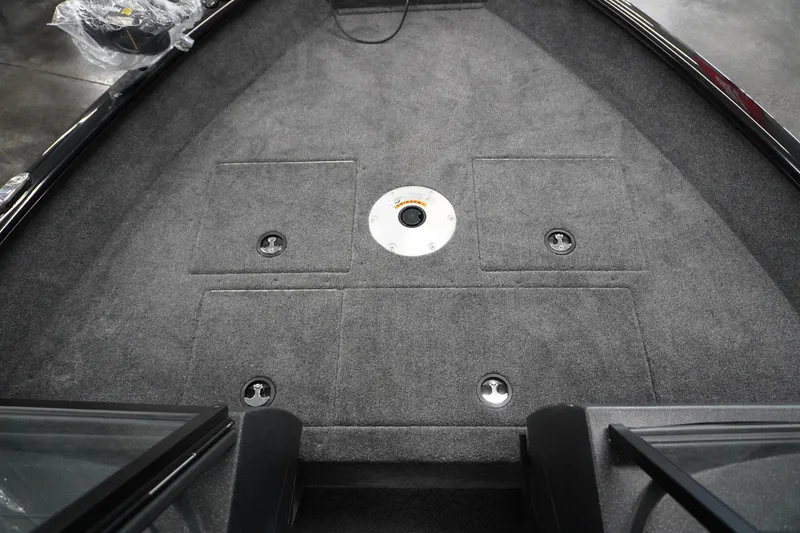 Slide: The Image of 2027 Tracker Pro Guide V-16 WT boat interior with carpeted deck and storage compartments. - 15