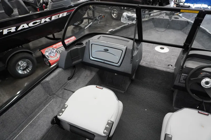 Slide: The Image of 2027 Tracker Pro Guide V-16 WT boat interior with seating and steering wheel. - 9