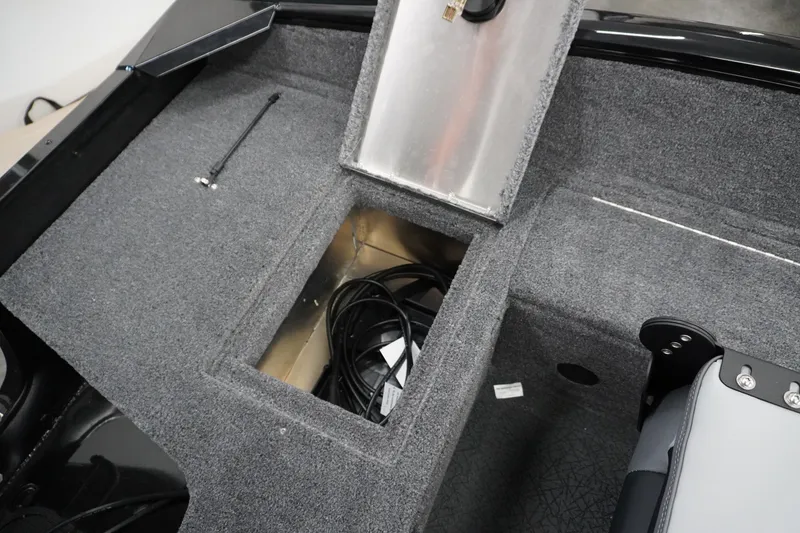 Slide: The Image of 2027 Tracker Pro Guide V-16 WT boat interior storage compartment with open hatch and cables. - 5