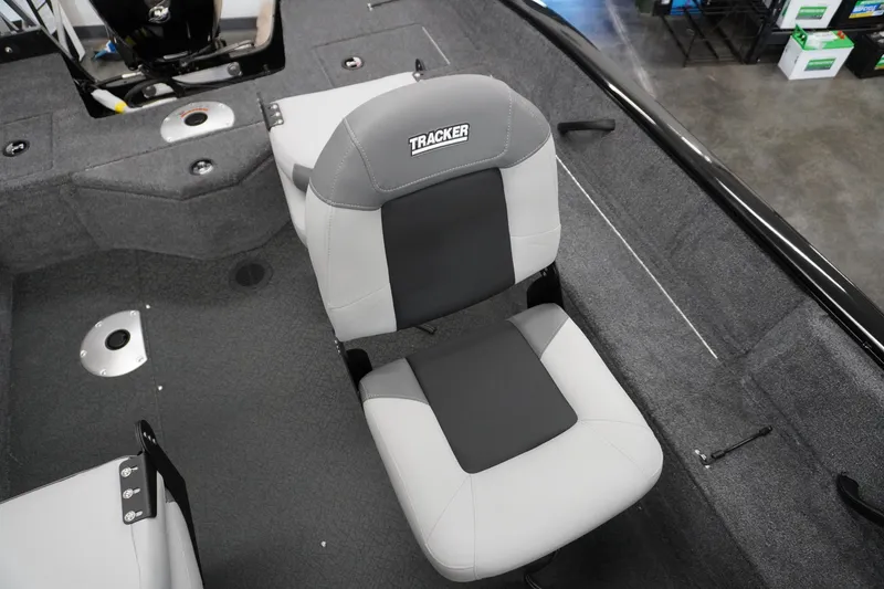 Slide: The Image of 2027 Tracker Pro Guide V-16 WT boat interior with gray seating and carpeted flooring. - 11