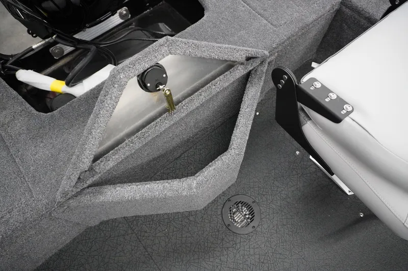 Slide: The Image of 2027 Tracker Pro Guide V-16 WT boat interior with storage compartment and seat detail. - 4
