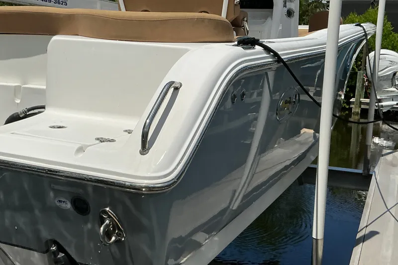 Slide: The Image of 2021 Sea Hunt Ultra 255SE boat docked, showcasing sleek design and modern features. - 44