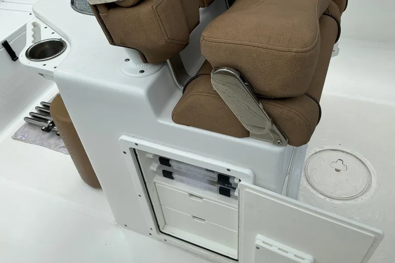 Slide: The Image of 2021 Sea Hunt Ultra 255SE boat interior with storage compartments and cushioned seating. - 9