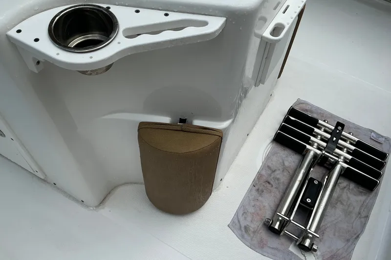 Slide: The Image of 2021 Sea Hunt Ultra 255SE boat interior with cup holder and folded ladder. - 25