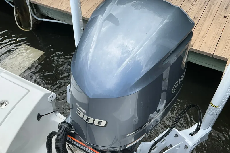 Slide: The Image of Yamaha 300 outboard motor on 2021 Sea Hunt Ultra 255SE boat docked by wooden pier. - 40