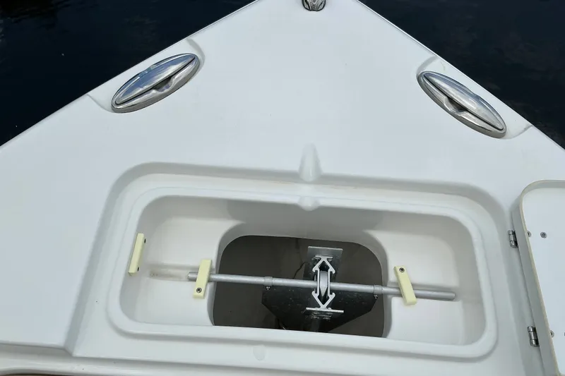 Slide: The Image of Bow anchor compartment of 2021 Sea Hunt Ultra 255SE boat, featuring stainless steel fittings. - 11