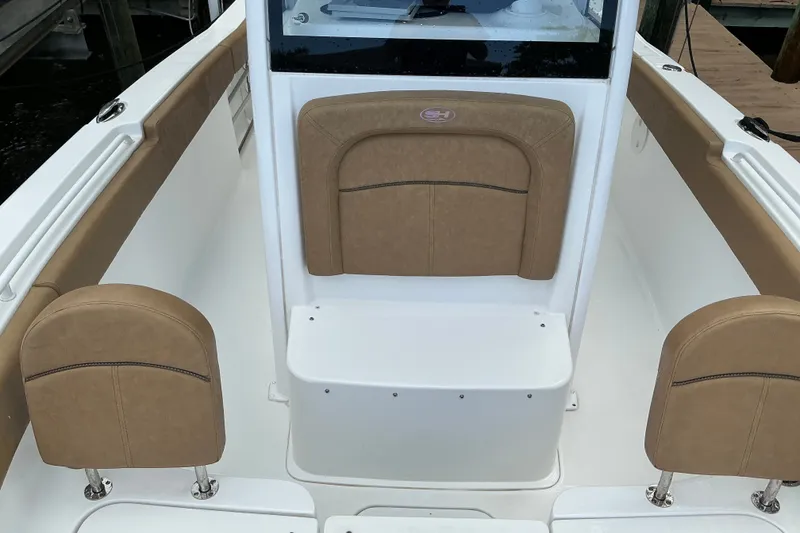 Slide: The Image of 2021 Sea Hunt Ultra 255SE boat interior with tan seating and white deck. - 13