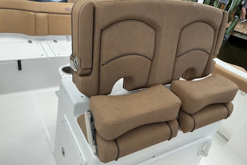 Slide: The Image of 2021 Sea Hunt Ultra 255SE boat with tan cushioned seating and white deck. - 8