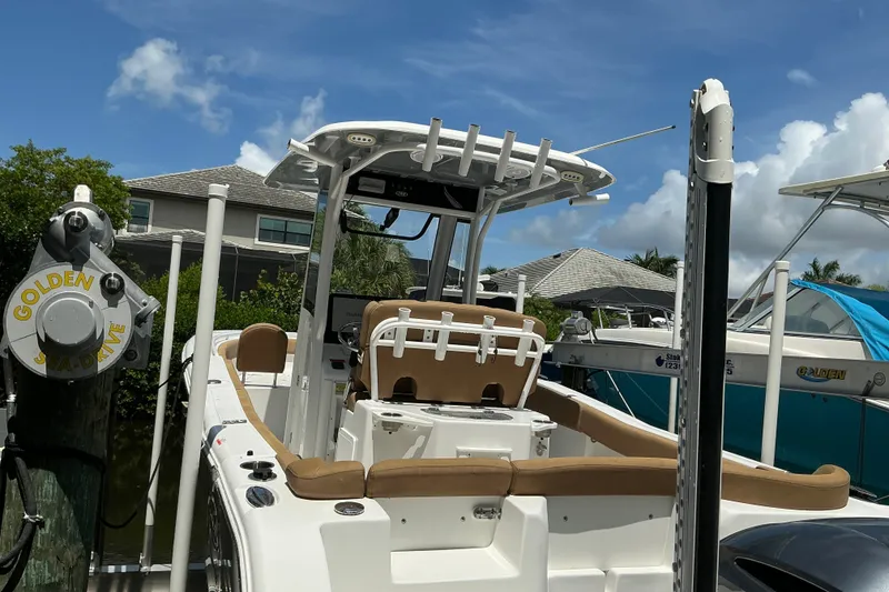 Slide: The Image of 2021 Sea Hunt Ultra 255SE boat docked, featuring a sleek design and spacious seating. - 43