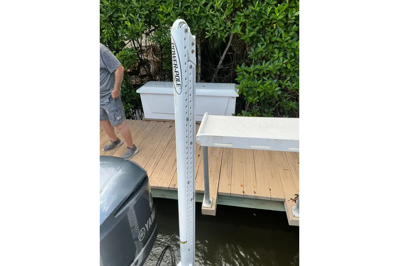 Slide: The Image of 2021 Sea Hunt Ultra 255SE with Power-Pole anchor on wooden dock. - 23