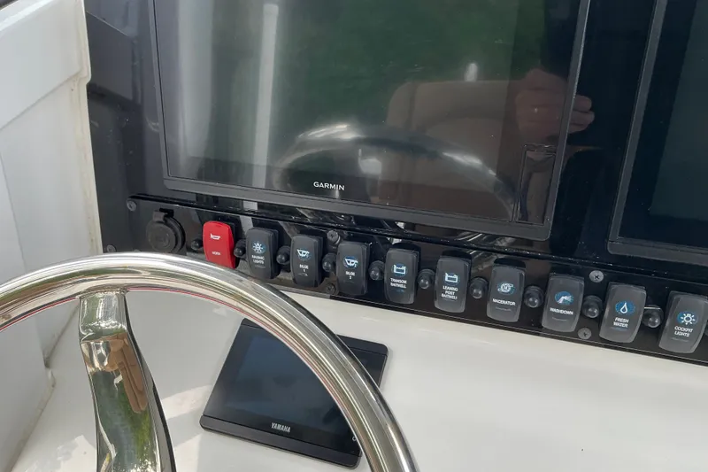 Slide: The Image of Control panel of 2021 Sea Hunt Ultra 255SE boat with Garmin display and switches. - 1