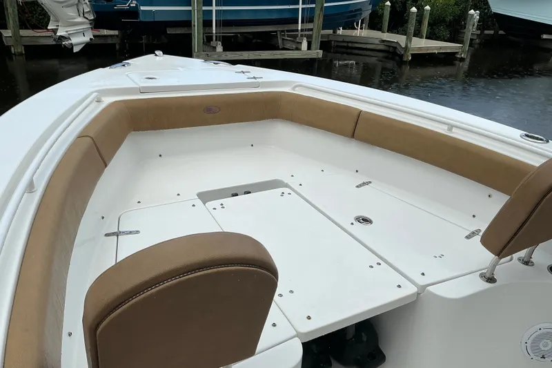 Slide: The Image of 2021 Sea Hunt Ultra 255SE boat interior with tan seating and white deck. - 10