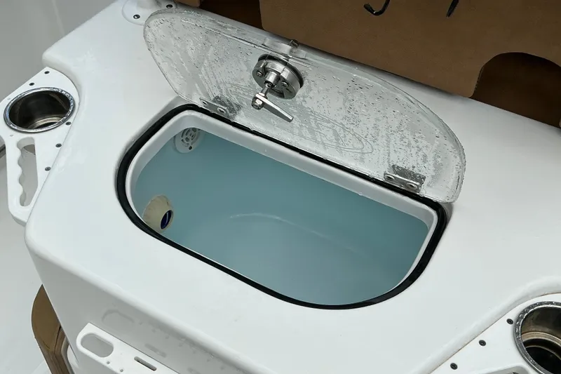 Slide: The Image of Livewell on a 2021 Sea Hunt Ultra 255SE boat, featuring a transparent lid and cup holders. - 17