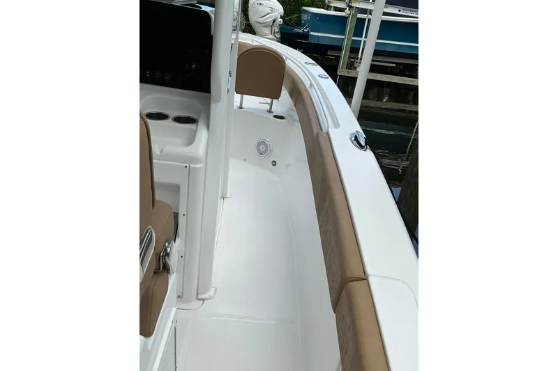Slide: The Image of 2021 Sea Hunt Ultra 255SE boat interior with tan seating and white deck. - 19