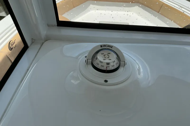 Slide: The Image of Compass on 2021 Sea Hunt Ultra 255SE boat dashboard, showing navigation details. - 32