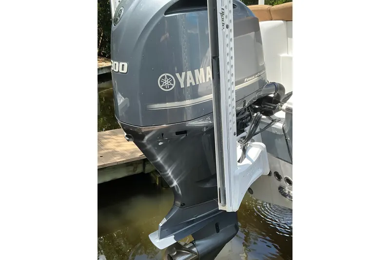 Slide: The Image of Yamaha outboard motor on 2021 Sea Hunt Ultra 255SE boat, docked by water. - 39