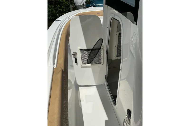 Slide: The Image of 2021 Sea Hunt Ultra 255SE boat interior storage compartment with open door. - 30