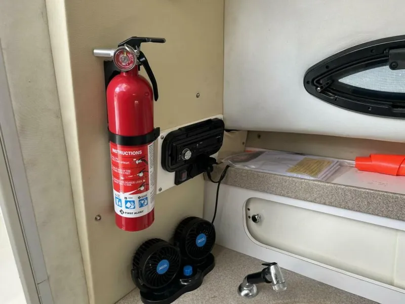 Slide: The Image of Boat interior with a fire extinguisher, fans, and a small sink. - 9