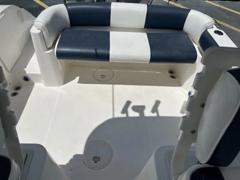 Slide: The Image of The image shows the seating area of a 2006 Century 2400 Walk-Around boat with blue and white upholstery. - 14