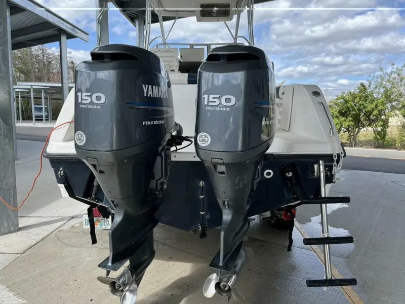 Slide: The Image of The image shows the rear of a 2006 Century 2400 Walk-Around boat with two Yamaha 150 outboard engines. - 2