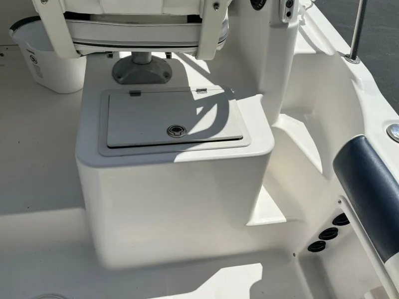 Slide: The Image of The image shows a boat's seating area with a white seat and a storage compartment beneath. - 6