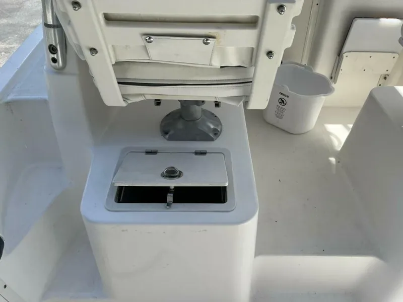 Slide: The Image of The image shows a boat's seating area with a white seat and a small storage compartment below. - 5