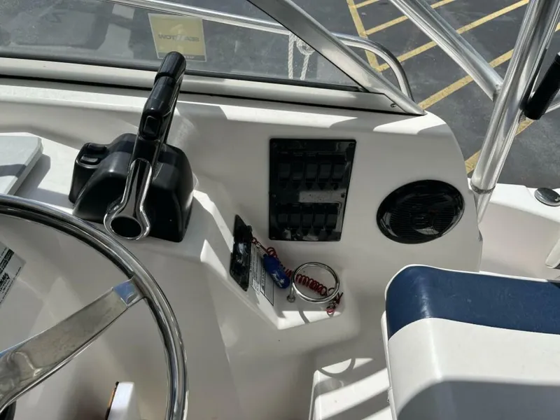 Slide: The Image of The image shows the cockpit of a 2006 Century 2400 Walk-Around boat with steering and controls. - 4