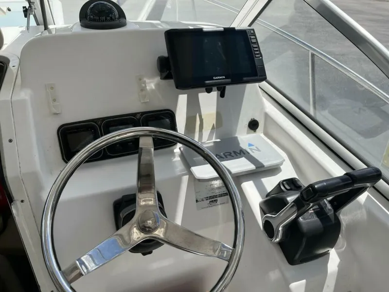 Slide: The Image of The image shows the helm of a 2006 Century 2400 Walk-Around boat with a Garmin navigation system. - 7