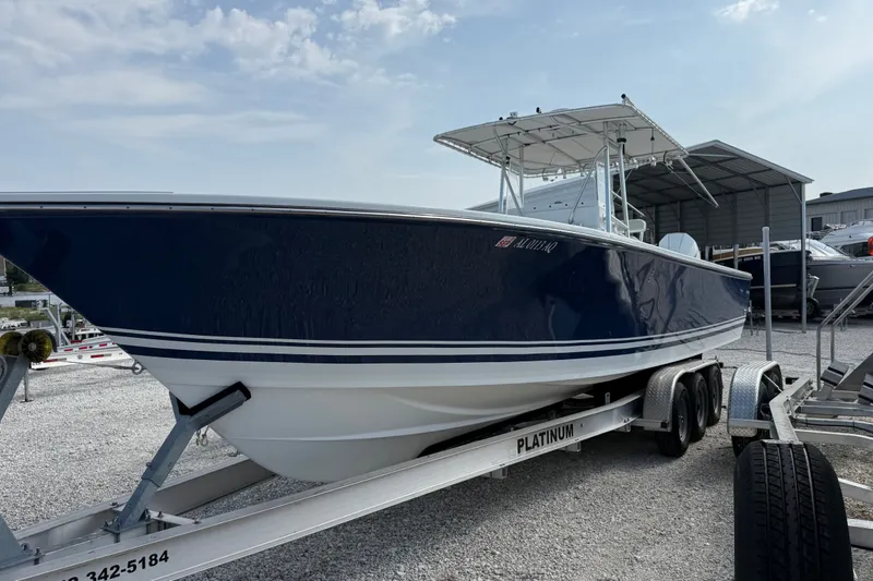 Slide: The Image of 2007 SeaCraft SC 32 Master Angler boat on trailer, parked outdoors under a cloudy sky. - 1